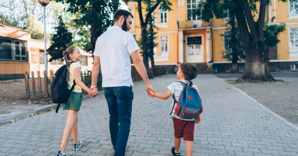 A man walking with his two children contemplating about mediation in family law