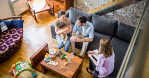 A family discusses a family report assessment with a woman in an office filled with toys.